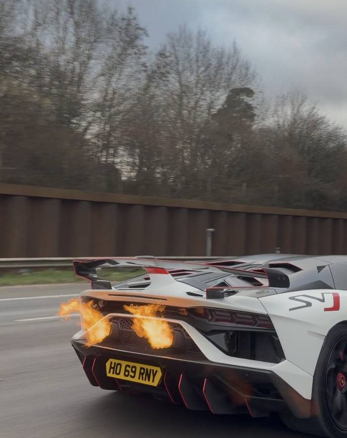 White Lamborghini SVJ with flames from the exhaust